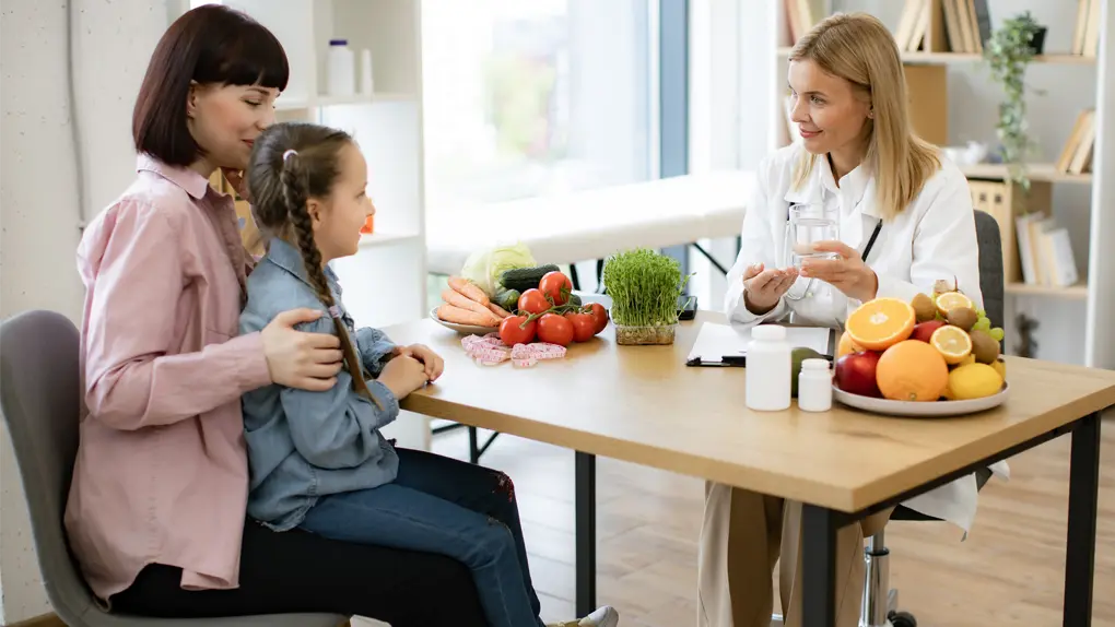Dietitian sitting with parent and child in office